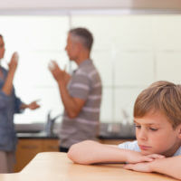 Parent arguing in front of a little boy