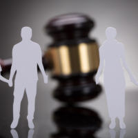 divorce image two paper dolls in front of a gavel